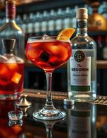 Vibrant cocktail sitting on a bar counter with garnish and bottles in the background photo