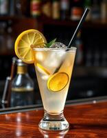 Refreshing cocktail garnished with lemon served in a stylish glass at a vibrant bar during the evening photo