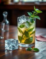 Refreshing mint cocktail with ice on a wooden table in a cozy bar during the evening hours photo