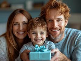 In warm setting father assists his eager son in unwrapping small gift while mother looks on loving smile celebrating together during festive occasion photo