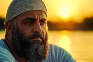 Middle Eastern rower leg prosthetic focuses intently while practicing in tranquil lake sunrise bathed in soft light and reflections of morning sun photo
