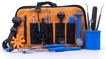 A collection of dental tools arranged neatly on an orange bag with a blue cup in the background photo