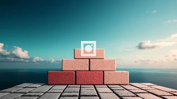 A colorful arrangement of bricks stacked on a coastal platform under a clear blue sky photo