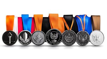A collection of various medals with colorful ribbons displayed in a neat row, symbolizing achievement photo