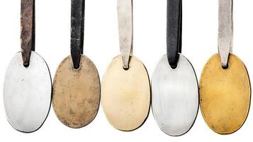A collection of five distinct metal tags showcasing various finishes and textures arranged in a row photo