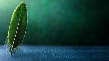 A green feather on a table with a green background photo
