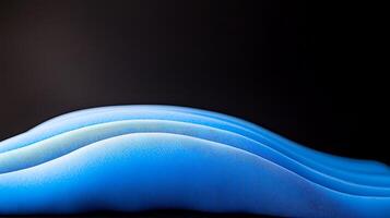 A blue object on a black background photo