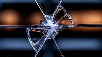 A broken glass window with a reflection of a light photo