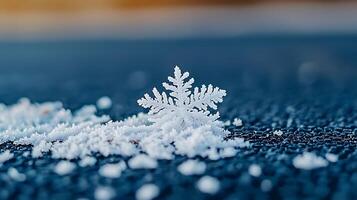 A snowflake is sitting on top of a blue surface photo