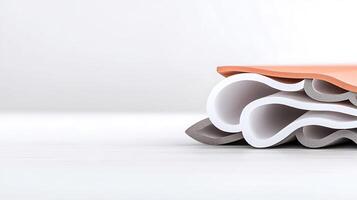 A stack of folded paper on a white surface photo