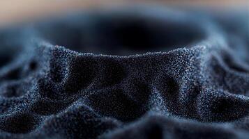 Close-up of a textured black sand formation with intricate patterns and soft lighting photo
