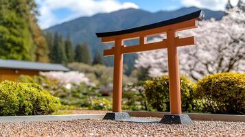 A tori gate in a garden with a mountain in the background photo
