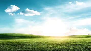 A green field with a blue sky and clouds photo