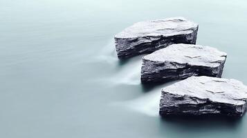 Three large rocks in the water with a long exposure photo