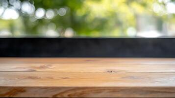 Wooden tabletop in a bright cafe setting with blurred greenery in the background photo