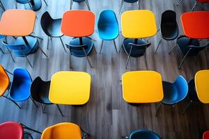 Colorful tables and chairs forming a vibrant and playful pattern in a modern cafeteria photo