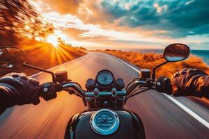 Motorcyclist driving along coastal highway at sunset enjoying freedom and adventure photo