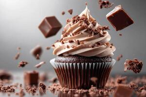 Delicious chocolate cupcake with chocolate chips and frosting exploding photo