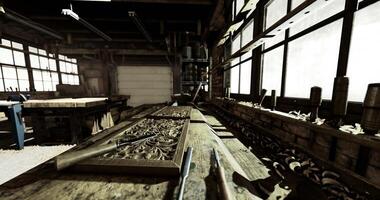 Workshop interior with tools and wood on a table in daylight hours video