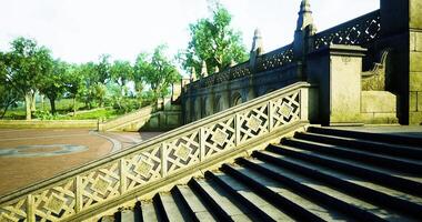 Staircase with intricate railing design in a lush park setting during daylight video