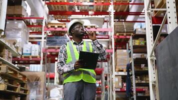 Logistics manager working in a large distribution warehouse video