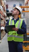 Logistics manager working in a large distribution warehouse video