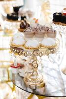 Delicious macarons and pastries decorating luxurious candy bar buffet. photo