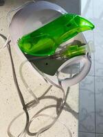 Compact nebulizer machine with green chamber on a light surface photo