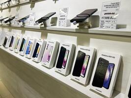 Kyiv, Ukraine - February 04, 2025 Display of packaged Samsung smartphones on a shelf at an electronics store photo