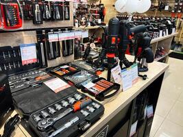 Kyiv, Ukraine - February 04, 2025 Various tools and power equipment displayed on a store shelf for sale. photo