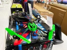 Kyiv, Ukraine - February 04, 2025 Green and black remote controlled drone displayed in a technology store showcase photo