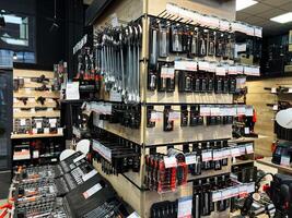 Kyiv, Ukraine - February 04, 2025 Assorted hand tools organized in tool store display with various sets and kits photo