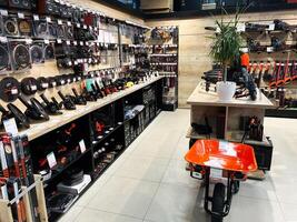 Kyiv, Ukraine - February 04, 2025 Hardware store aisle with equipment and tools displayed on shelves and racks photo