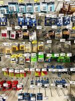 Kyiv, Ukraine - February 04, 2025 Variety of batteries displayed on store shelf with brands and prices visible photo