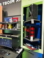 Kyiv, Ukraine - February 04, 2025 Gaming setup display including accessories and custom PC cases in a modern store photo
