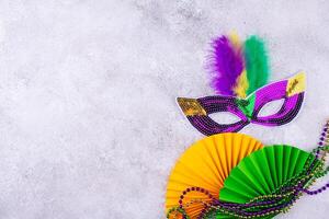 Vibrant Mardi Gras background with mask, beads, and festive decorations photo