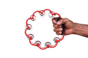 Close up hand hold the tambourine on white background. Concept, playing musical instrument. photo