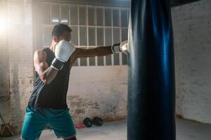 Engaging in Dynamic Boxer Training sessions utilizing a Heavy Bag in a Gym Environment photo