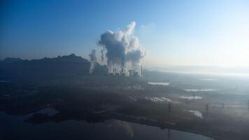 Aerial view of a coal-fired power plant with steam flowing out of the stack in the morning. Mae Moh Power Plant. photo