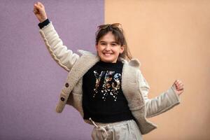 Happy teenage girl dancing and jumping on isolated the background. photo