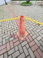 Traffic Cone with Chains on Paved Surface photo