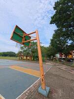 Rustic Basketball Hoop with Cloudy Sky Background photo