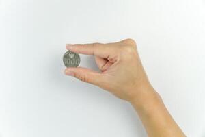 A person holding a coin with a heart on it photo