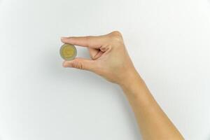 A person holding a coin in their hand photo