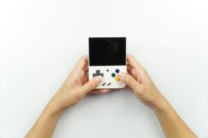A person holding a game console with a game controller photo