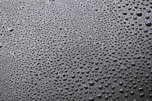 Water droplets with black background. Suitable for wallpaper cover design photo