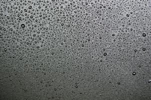 Stright view of water droplets with dark background suitable for wallpaper photo