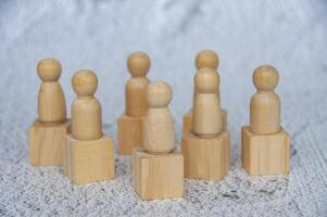 Wooden figure dolls on top of wooden cube representing that everyone is a winner photo