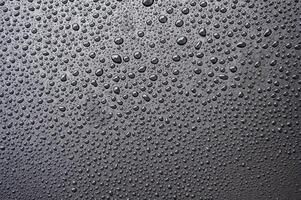 Water droplets with black background. Suitable for wallpaper background photo