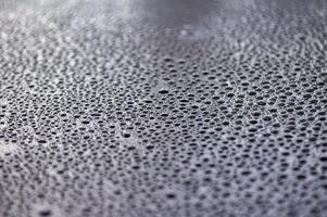 Close up of clear water droplets with black background. Suitable for wallpaper cover design photo